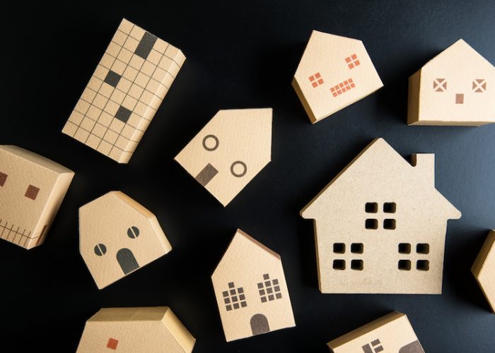 Wooden house toy on black background with copy space.Real estate concept, New house concept, Finance loan business concept