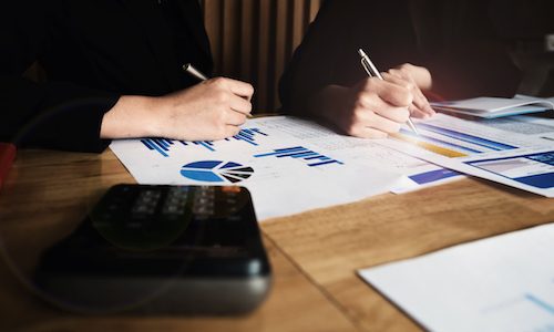 Close up Business woman and partner using calculator for calculating finance, tax, accounting, statistics and analytic research, group support and meeting concept